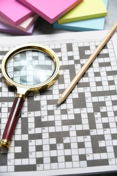 Crossword, magnifying glass and pencil. Set for training mind